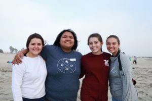 San Diego Christian College students pose on the sandy shore
