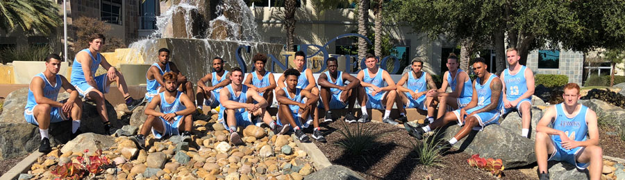 San Diego Christian College mens basketball team pose in front of the SDCC fountain