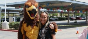 San Diego Christian College Hawks mascot poses with student